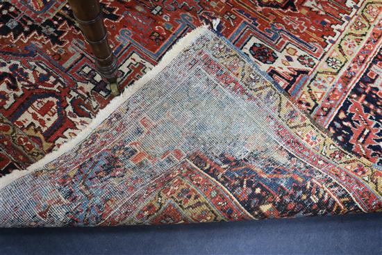 A Persian Heriz red ground carpet, 380 x 280cm, worn